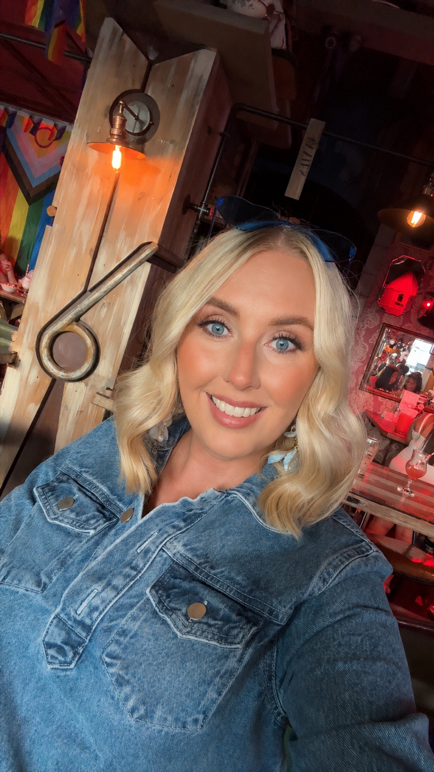 Rebecca smiling in a denim outfit